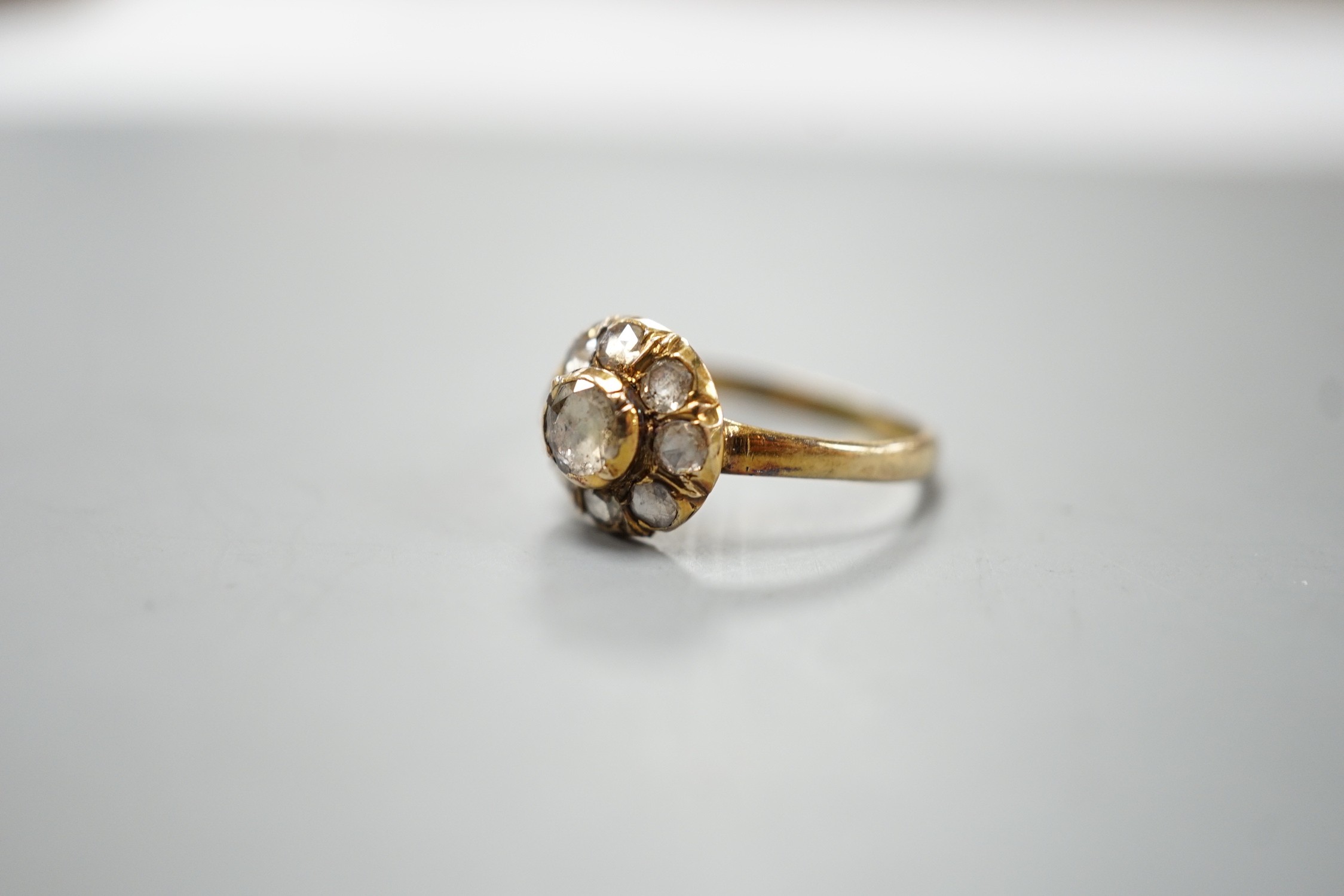 An antique yellow metal and rose cut diamond cluster set ring, size K/L, gross weight 3.2 grams.